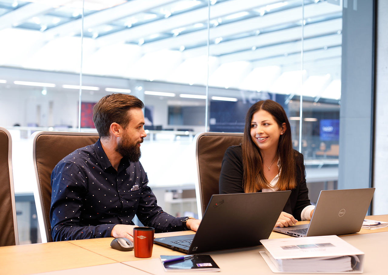 Two colleagues sitting at desk